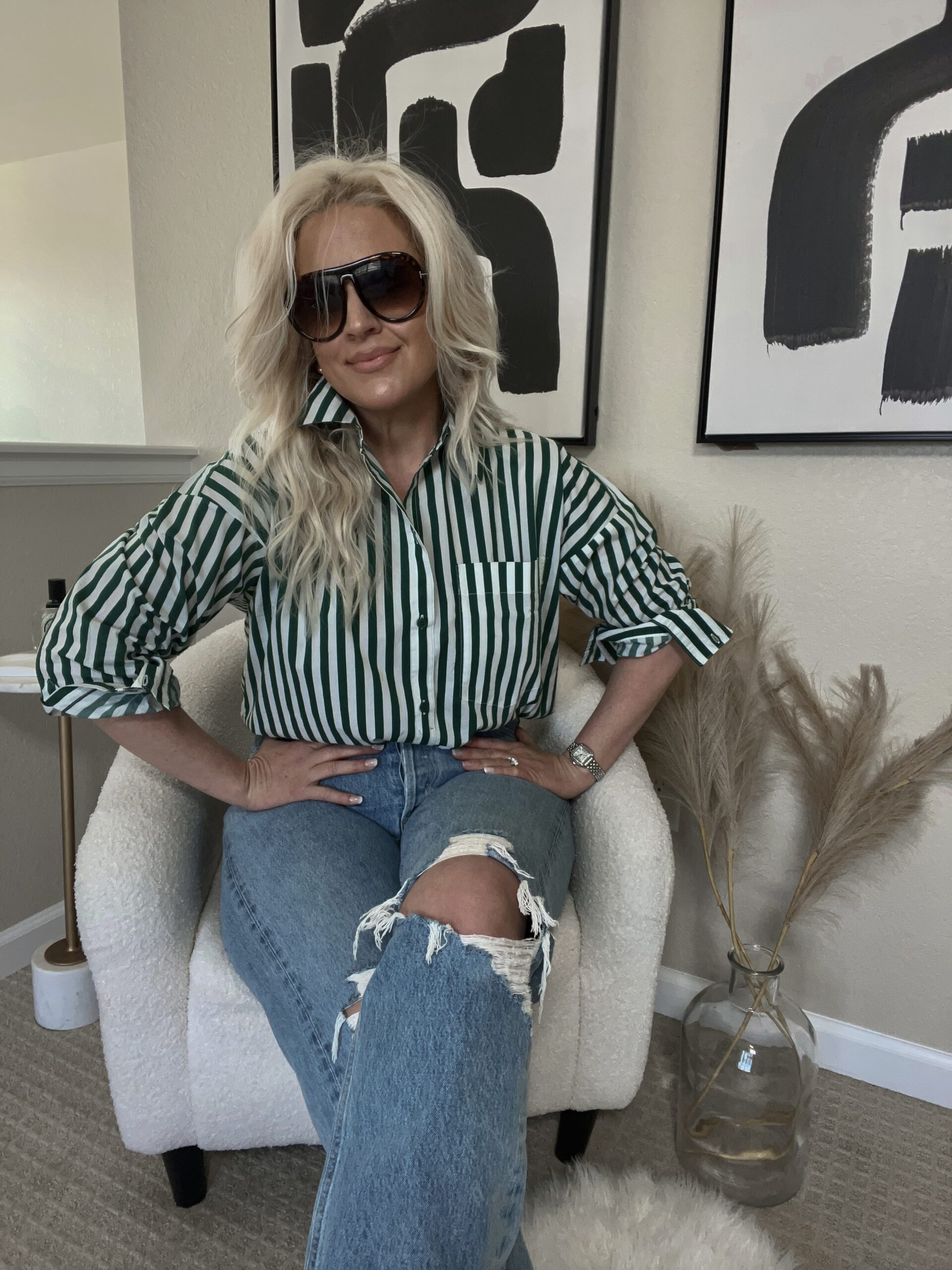 Image of Lindsey Denver wearing a green and white striped top paired with Agolde jeans, showcasing a trendy and stylish outfit.