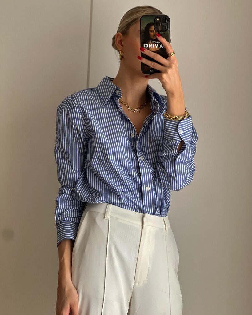 lydia tomlinson wearing white trousers and blue white stripe blouse.