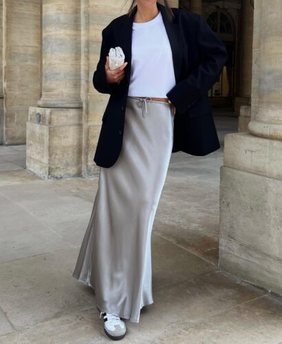 image of minimalist outfit that includes long satin skirt, shirt, blazer and Adidas Sambas.