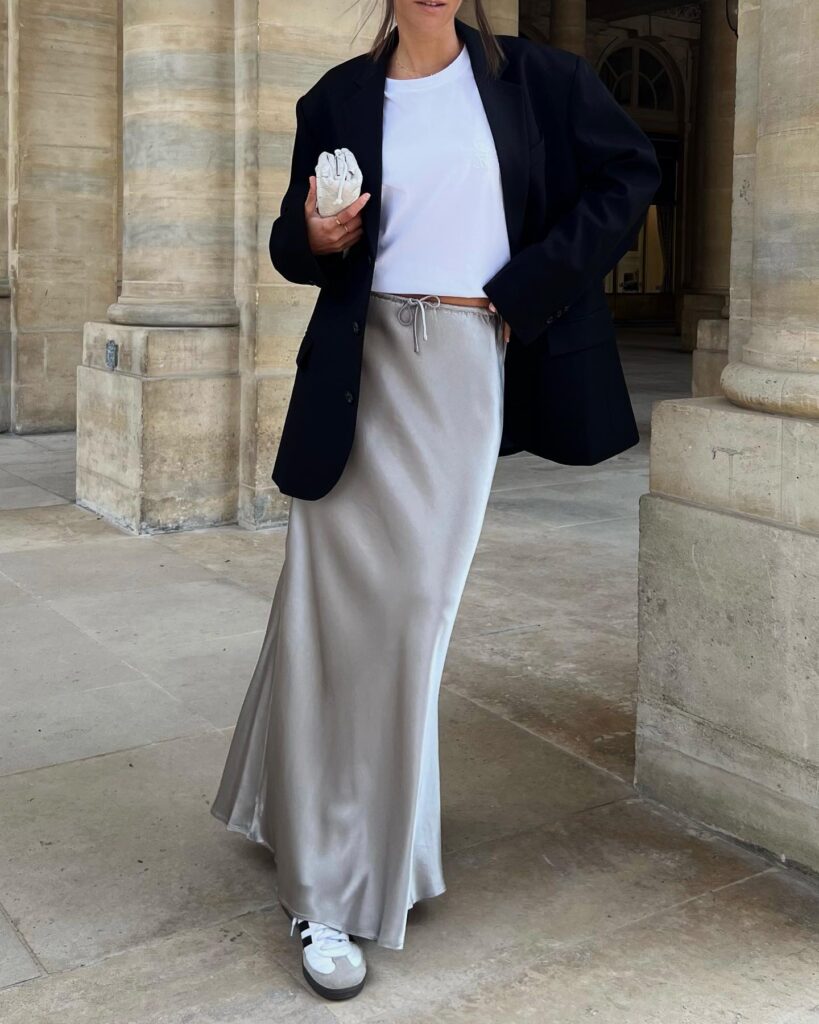 image of minimalist outfit that includes long satin skirt, shirt, blazer and Adidas Sambas.